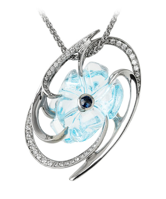 FLOWER AQUA PENDANT Platinum pendant featuring a 21.68ct free form aquamarine accented with a 0.16ctw blue sapphire and 0.335ctw white diamonds. Price includes chain.