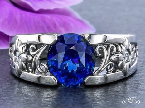 A stunning sapphire surrounded by diamond flowers and delicate filigree curls. At Green Lake Jewelry Works