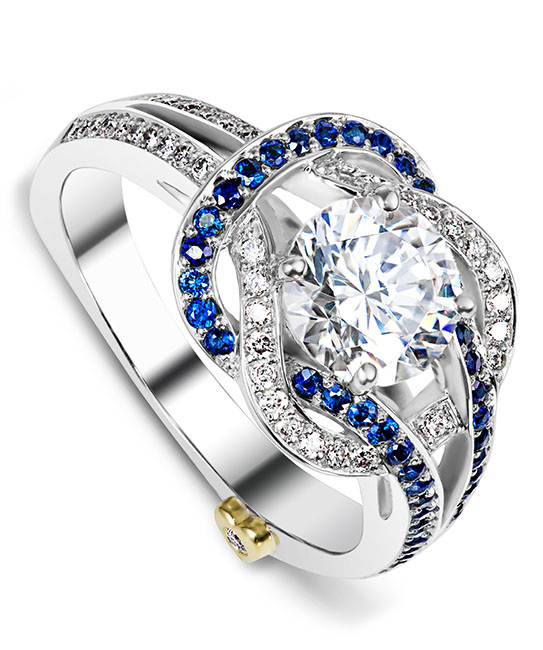 The Entangle engagement ring contains 49 diamonds totaling 0.245ctw and 41 sapphires totaling 0.205ctw. Center stone sold separately, not included in price. The Entangle wedding band contains 46 diamonds, totaling 0.23ctw.