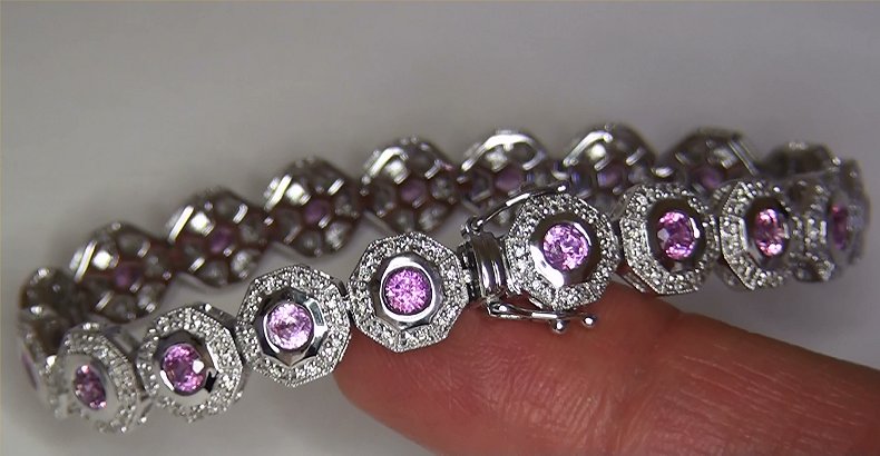 A substantial 7.18 carat estate bracelet featuing genuine VS clarity Natural Ceylon Pink Sapphires set into SOLID 14k white gold with sparkling natural accent diamonds. There are 19 bezel set round brilliant cut pink sapphires measuring approximately 3.81 mm each with a combined weight of approximately 6.16 carats. These exceptional Pink Sapphires offer VS clarity with only minor inclusions and display a rich pink color with excellent saturation and balance. Additionally, there are 304 ROUND BRILLIANT natural accent diamonds totaling and additional 1.02 carats. These Perfectly Clear diamonds are graded at Near Flawless to Eye Clean "VS2-SI2" clarity with NEAR COLORLESS "G-H-I" color so you can be assured of the superior quality, excellent brilliance, flash, sparkle & fire. 