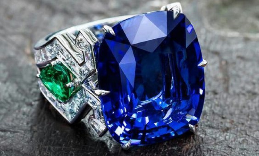 Dive into infinite blue with this 23 carat sapphire… Burmese cushion-cut sapphire set with emeralds and diamond baguettes
