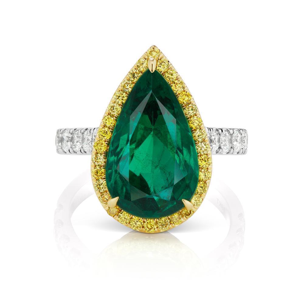 EMERALD AND DIAMOND RING A splendid emerald pear shape surrounded by a rich yellow diamond halo. A classic color combination in a contemporary styling.