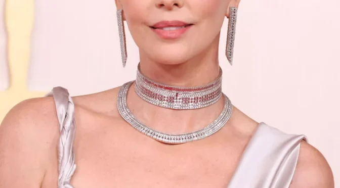 Charlize Theron wears a shimmering Boucheron choker and earrings